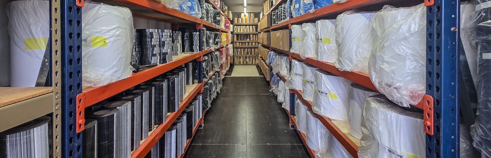 Material inventory on racks along the Donek Supply warehouse aisle